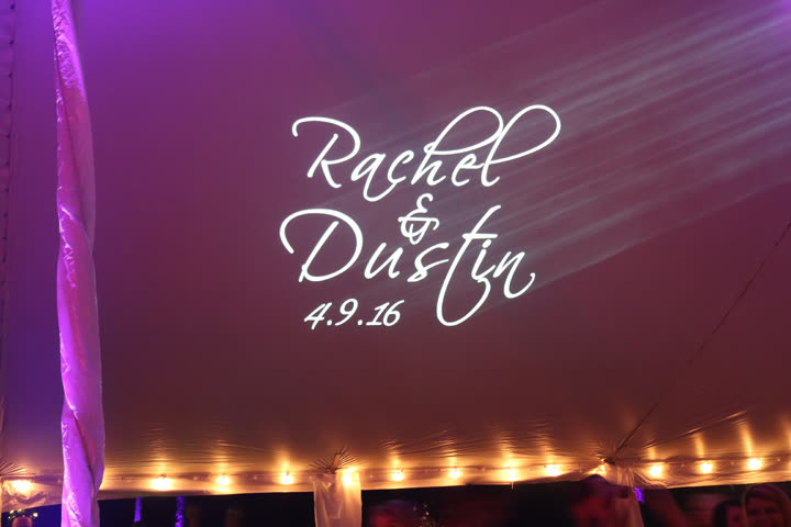 Custom wedding monogram projected on a reception tent ceiling